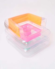 three plastic containers are stacked on top of each other, with one container in the middle