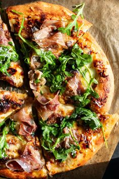 a pizza topped with lots of toppings on top of a table