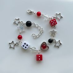 a stunning handmade charm bracelet. decorated with red, black & white beads, silver hanging star charms, hearts, and dice. adjustable chain to fit any wrist. can be personalised with different colours & charms (prices may vary). perfect for the 'stargirl' aesthetic! Handmade Red Metal Charm Bracelet, Red Dangle Bracelets As Gift, Red Metal Bracelets With Charms, Electric Drum Set, Stargirl Aesthetic, Lana Del Rey Aesthetic, Rey Aesthetic, Handmade Charm Bracelets, Funky Jewelry