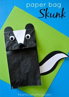 an animal made out of black paper on top of a green and blue background with the words, paper bag skunk