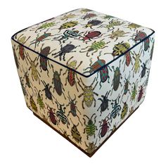 an upholstered ottoman with bugs on it