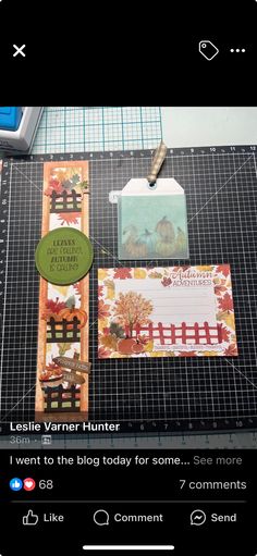 a table topped with lots of cards and paper on top of a cutting board next to scissors