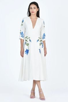 Stunning and timeless midi dress with flattering V-neck front and 3/4 length sleeves. The delicate blue floral embroidery draws inspiration from hydrangeas, adding a touch of sophistication to the fit and flare silhouette. 100% Cotton, Made to Order. Experience Fanm Mon, crafted for your most delightful moments. Spring Floral Embroidered V-neck Midi Dress, Spring Floral Embroidery V-neck Midi Dress, Spring Formal Midi Dress With Floral Embroidery, Elegant Dresses With Floral Embroidery And 3/4 Sleeves, Elegant V-neck Midi Dress With Floral Embroidery, Elegant 3/4 Sleeve Dresses For Garden Party, Elegant Dresses For Garden Party With 3/4 Sleeve, Formal Floral Embroidered Midi Dress With V-neck, Formal Floral Embroidery V-neck Midi Dress