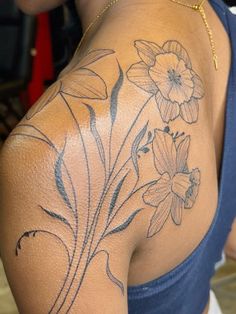 the back of a woman's shoulder with flowers on it