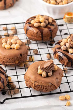 When you have a craving for peanut butter, these Peanut Butter Donuts hit the spot! Moist and fluffy, these baked treats are infused with warm cinnamon and sweet vanilla, all highlighted by the rich flavor of peanut butter. They're topped with a luscious chocolate ganache and colorful mini Reese’s Pieces for a fun fall twist. #deliciousdonut #yummyrecipe #crispydonut #baking101 #homemade Pumpkin Donuts Recipe, Reese's Peanut Butter Cup, Banana Flour, Healthy Donuts, Baking 101, Donut Holes, Homemade Donuts, Peanut Butter Cup, Delicious Donuts