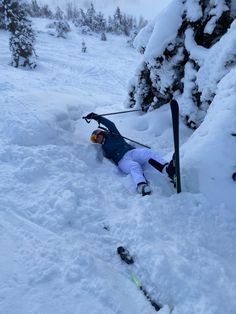 a person on skis laying in the snow