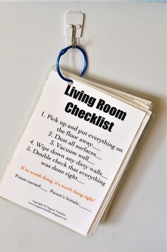 a living room checklist hanging on the wall next to a door hanger with an ad for living room checklist