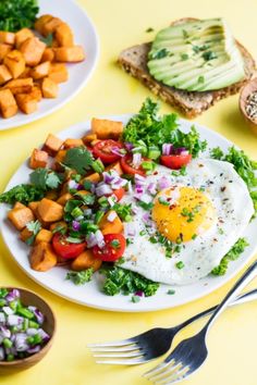 an egg is on top of a salad with carrots and other foods around it