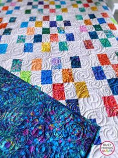 two quilts that have been made together and one is blue, green, yellow, orange