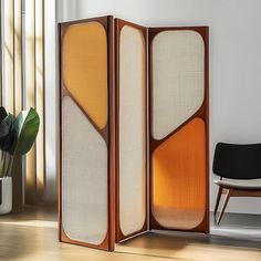 the room divider is made from wood and has two panels with different colors on them