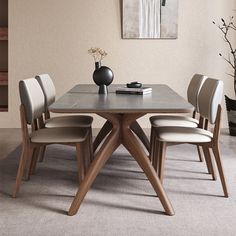 a dining room table with four chairs around it