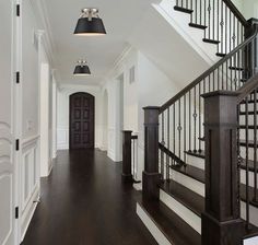 an empty hallway with stairs and lights