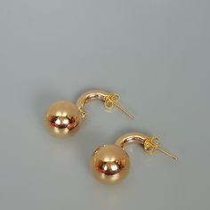 A PAIR of gold dipped drop and dangle earrings. A semi circle stud with a hanging ball. Size: Length: 26 mm Ball: 12 mm Weight: 2.45 gm These earrings are made of real 925 hypoallergenic sterling silver, dipped in real gold. Will be packaged in a gift box. I can write out a message from you to the receiver if needed. Please be free to contact me at... bhavnakwintra1956@gmail.com More hoops: https://www.etsy.com/your/shops/TheSilverGame/tools/listings/section:26305414 More earrings: https://www.e Minimalist Gold Plated Earrings For Party, Minimalist Gold Dangle Earrings, Gold Minimalist Dangle Earrings, Minimalist Gold Plated Drop Earrings, Gold Minimalist Pierced Plug Earrings, Modern Gold Drop Plug Earrings, Minimalist Gold Metal Plug Earrings, Minimalist Gold Drop Plug Earrings, Gold Minimalist Drop Plug Earrings