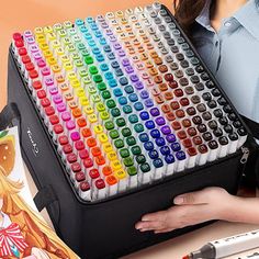 a woman is holding a large multicolored keyboard