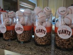 some glass jars filled with baseballs and peanuts