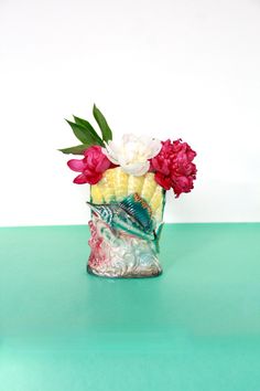 a vase filled with flowers on top of a green table