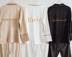 three pajama sets with bride and groom's names hanging on the wall