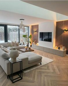 a modern living room with wood floors and large windows