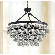 a chandelier hanging from the ceiling with lots of crystal balls on it's black frame