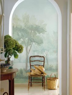 an archway leading into a room with a painting on the wall and a chair next to it