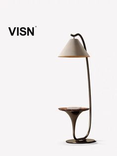 the visn table lamp has a white shade on it