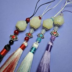 the tassels are decorated with beads and other things to wear on their necklaces