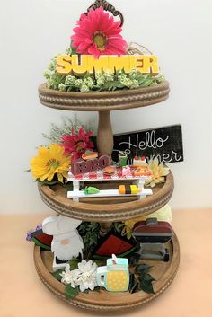 three tiered tray with flowers and writing on it that says summer in large letters