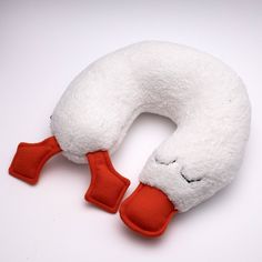 a close up of a stuffed animal toy on a white surface with one eye closed