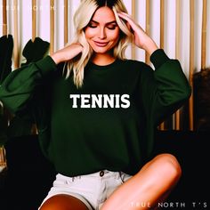 Elevate your casual wardrobe with our Unisex Tennis Sweatshirt, a perfect blend of comfort and style. Crafted from premium, soft cotton, this sweatshirt features the word "TENNIS" boldly  across the front, making it a must-have for tennis enthusiasts. Whether you're heading to the court or lounging at home, this versatile piece offers a relaxed fit that suits any occasion. Available in a variety of sizes, classic colors and option to change sport, our Tennis Sweatshirt is designed to keep you co Green Athleisure Tennis Top, Green Athleisure Top For Tennis, Relaxed Fit Crew Neck Top For Tennis, Crew Neck Tennis T-shirt With Letter Print, Tennis Graphic Print Sweatshirt For Sports Season, Tennis Graphic Print Sweatshirt, Sporty Tennis Sweatshirt With Graphic Print, Green Casual Tennis T-shirt, Green Cotton T-shirt For Tennis