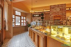 the inside of a bakery with lots of food on display