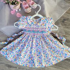 Celebrate Your Baby's Special Day In Style With Our Floral Smocked Embroidered Dress. Beautifully Crafted Garment That Exudes Elegance And Charm. Timeless Design | Vintage Victorian Floral Print | No Lined | Not See-Through. Details : - Breathable 100% Cotton. - Peter Pan Collar And Puffy Sleeves. -Precious Turquoise Rose-Buds And Pink Zic Zac Hand Smocking Across The Chest. - Matching Buttons To Assist With Dressing On A Back. - Adjustable Waist Tie. Runs True To Size. ! ! Matching Bloomers For Cute Fitted Multicolor Smocked Dress, Cute Multicolor Fitted Smocked Dress, Fitted Multicolor Dress For First Birthday, Cute Multicolor Smocked Dress, Floral Print Smocked Dress For Playtime In Summer, Playful Fitted Smocked Dress For Playtime, Playful Fitted Smocked Dress, Multicolor Smocked Dress For Summer Playtime, Spring Fitted Smocked Dress For Playtime