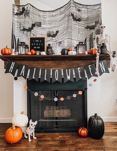 a fireplace decorated for halloween with pumpkins and decorations