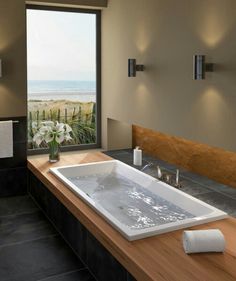 a large bath tub sitting next to a window