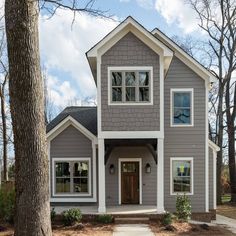 a gray house with white trim and windows