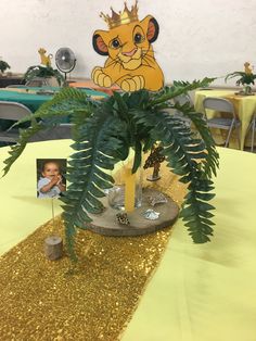 a table topped with a potted plant next to a photo on top of it