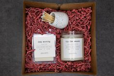 two candles in a box with matches