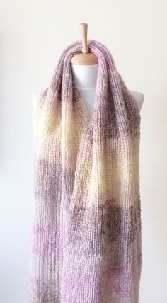 "This hand knit scarf is perfect and cozy accessory to keep you warm and stylilsh. This knit scarf is super large and wide made with softest and airy soft angora wool The scarf is long to make two loops, its very soft and comfortable. Material: extra soft and very light angora wool Color: Light Shades of Purple Pastel Yellow and very light Beige Width: 60 cm / 24\" Care: Handwash in luke warm water, lay flat to dry. Can also be washed in a washing mashing at gentle cycle, do not tumble dry 100% Cozy Soft Knit Scarf, Warm Cozy Scarves One Size, One Size Knitting Pattern For Acrylic Yarn Scarf, One-size Acrylic Yarn Scarf Knitting Pattern, Warm Yarn Scarves One Size, One Size Yarn Scarf, One Size Scarf Knitting Pattern, Warm Acrylic Yarn Scarves One Size, Warm Acrylic Scarves One Size