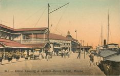 an old postcard shows people walking on the street in front of a large building