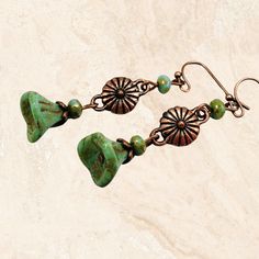 Add a bohemian touch to your jewelry collection with these rustic green dangle earrings. Handmade with Czech glass flowers and available in copper, silver or bronze. Select metal finish in dropdown menu: antique copper, bronze or silver. Hypoallergenic ear wires (nickel and lead free). Choose ear wire style at checkout.  Artisan glass beads produced in small quantities in the Czech Republic. A gift for you or someone special, earrings are carded and in an organza bag. Link back to my shop: https Czech Glass Dangle Earrings With Bead Caps, Green Flower-shaped Jewelry With Dangling Beads, Green Czech Glass Flower Earrings, Green Adjustable Dangle Flower Earrings, Unique Green Czech Glass Beaded Earrings, Green Copper Bead Earrings, Green Flower Earrings With Round Beads, Green Copper Round Bead Earrings, Green Dangle Jewelry With Bead Caps