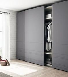 an empty bedroom with white brick walls and wooden floors