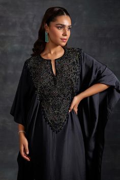 Black kaftan, highlighted with tonal embellished yoke. Paired with a pant.
Components: 2
Pattern: Embellished
Type Of Work:  Beads, Crystals
Neckline: Notched Neck
Sleeve Type: Three Quarter Sleeves
Fabric: Habutai Silk, Chantilly Lace
Color: Black
Other Details: 
Model height: 5ft 8inches, wearing size M

Occasion: Sangeet - Aza Fashions Black Kaftan, Pant For Women, Chantilly Lace, Three Quarter Sleeves, Aza Fashion, Model Height, Sleeve Type, Three Quarter, The House