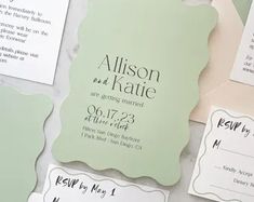 the wedding stationery is laid out on top of each other