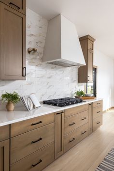 a stove top oven sitting inside of a kitchen next to wooden cabinets and counter tops