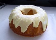 a bundt cake with white icing sitting on top of a table