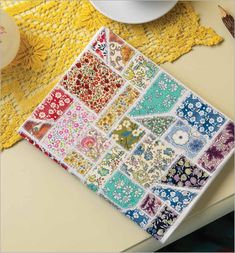 a table topped with lots of different types of quilts and crocheted placemats