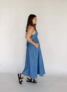 denim adjustable spaghetti straps tie back closure pockets empire waist elastic waistband in back 90% cotton, 10% polyester hand wash cold Abby is 5’6” wearing size small small: 32" bust // 49" length medium: 34" bust // 49" length large: 36" bust // 49" length Midi Maxi Dress, Solid Dress, Solid Tops, Tie Back, Empire Waist, Skirt Pants, Print Tops, Bottoms Pants, Set Dress