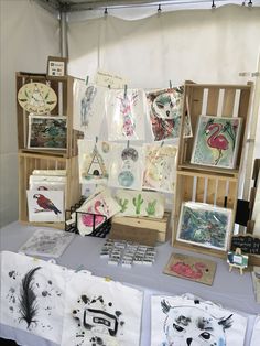 a table topped with lots of pictures and cards on it's sides next to wooden crates