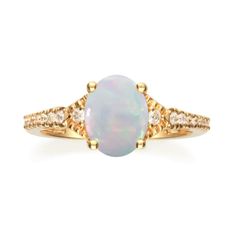 A lustrous oval-cut opal gemstone is set in a marquise-shaped setting of 10K yellow gold. Surrounded by brilliant diamond accent stones, this Gin & Grace ring is finished with a high polish. Gemstone colors: White Gemstone shapes: Oval One prong-set oval-cut Australian opal measures Gemstone weight: 1.08 carat Total gemstone weight: 1.08 carat Diamonds: 16 Diamond cut: Round Diamond measurements: Each measure 1 mm Diamond weight: 0.16 carat Color: G-H Clarity: I1-I2 Setting: Prong Metal: 10k Formal Oval Opal Ring With Gemstone Accents, Oval Cabochon Opal Ring With Accent Stones For Anniversary, Heirloom Oval Opal Ring With Diamond Accents, Heirloom Oval Opal Ring With Accent Stones, Oval Opal Ring With Diamond Accents In Yellow Gold, Oval Opal Ring In Yellow Gold With Diamond Accents, Oval Opal Ring With Gemstone Accents For Anniversary, Yellow Gold Oval Opal Ring With Center Stone, Elegant Oval Opal Ring With Gemstone Accents