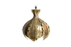 an antique brass hanging light fixture with intricate designs on the front and back sides, isolated against a white background