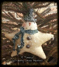 a snowman ornament hanging from a christmas tree